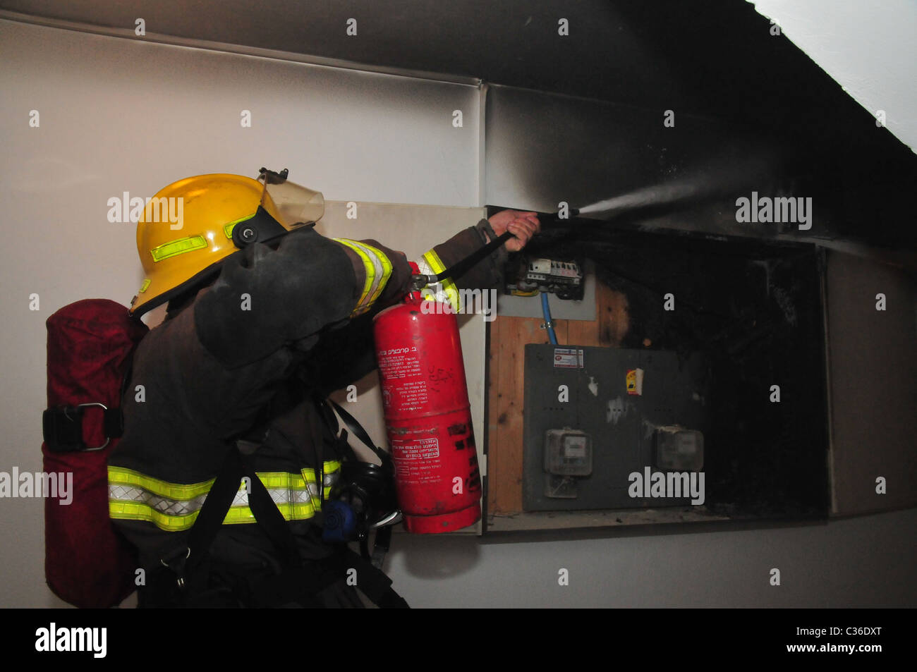 Fireman extinguishes the flames Stock Photo Alamy