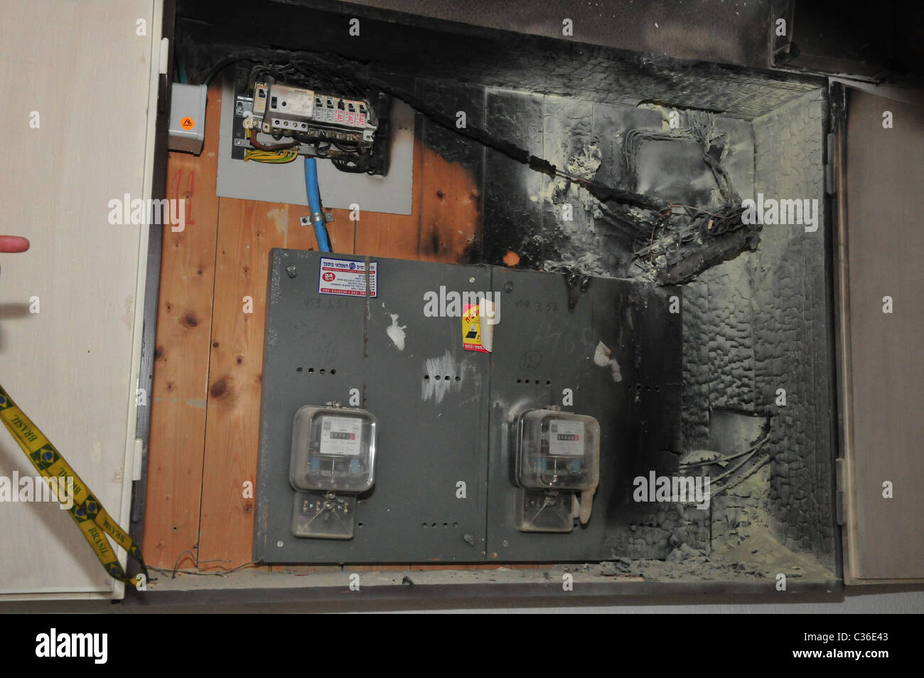 A fire broke out in a household electrical fuse box flames consumed the board. The burnt fuse box Photographed in Israel Stock Photo