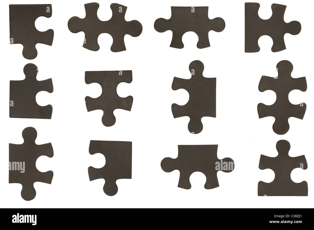different black puzzle pieces over white background Stock Photo