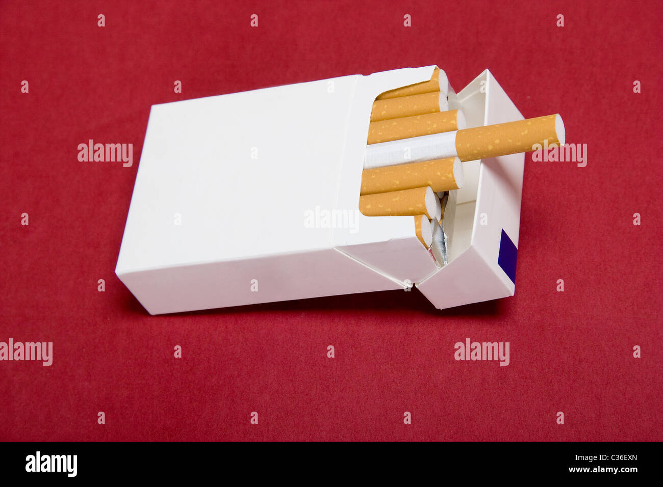 closeup of packet cigarettes on red background Stock Photo
