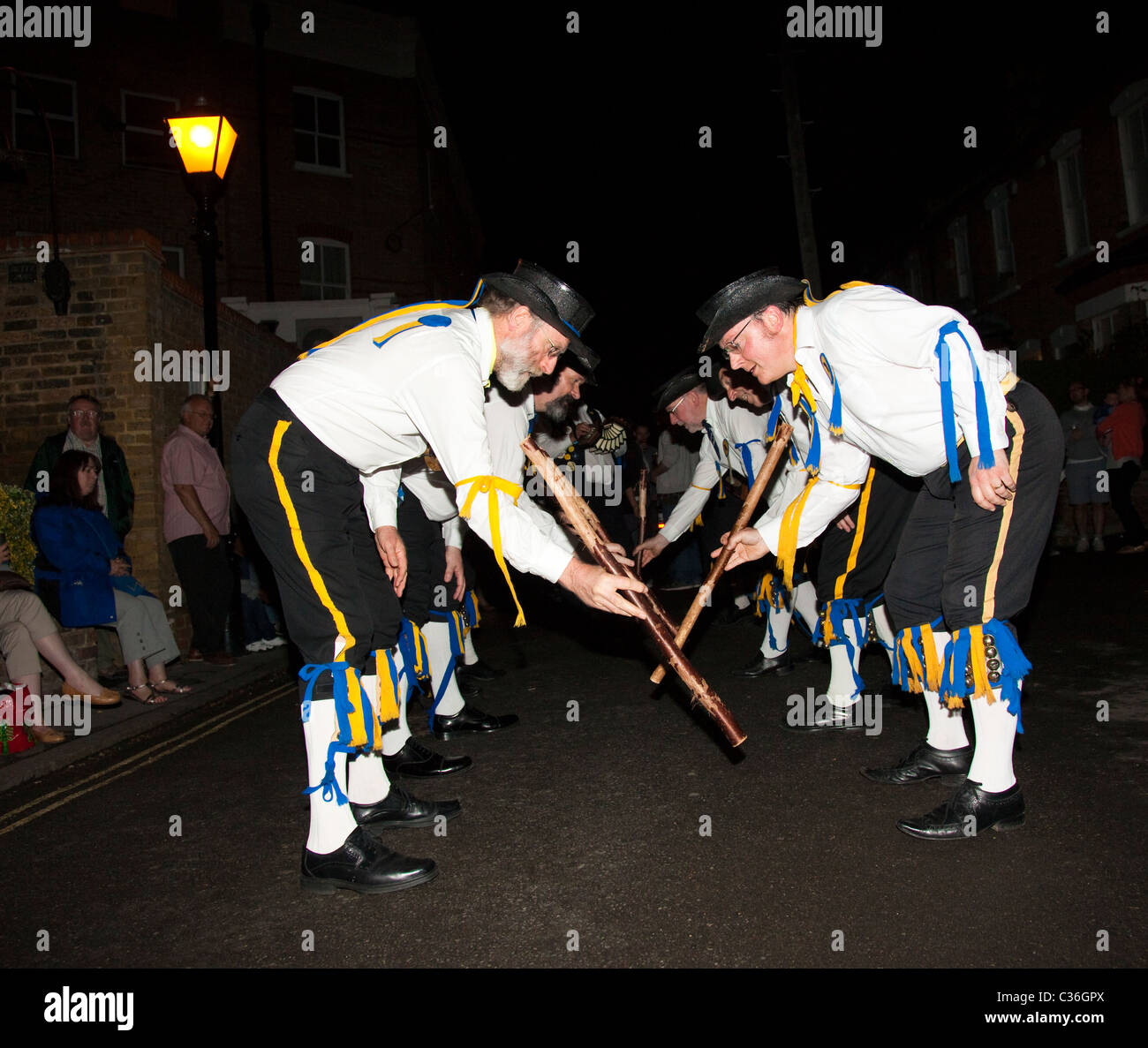 The Ravensbourne Morris Men perform at night outside a pub in North West Kent, UK. Stock Photo