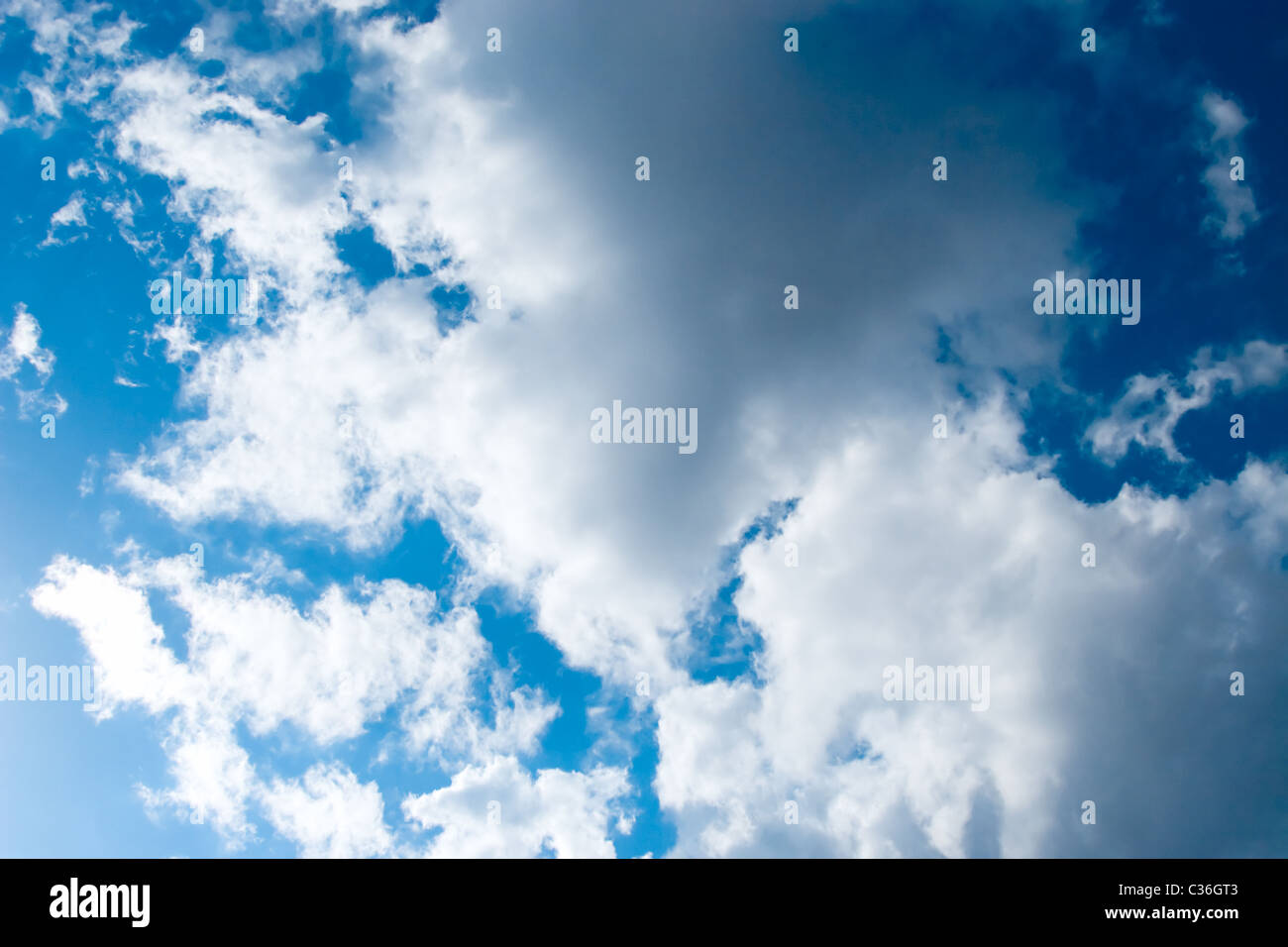 Blue sky with some white puffy clouds Stock Photo