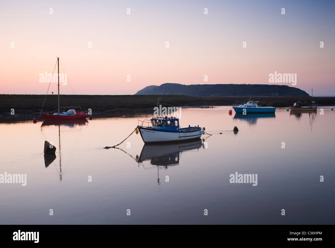 Boats moored on the River Axe with Brean Down in the distance. Somerset. England. UK. Stock Photo