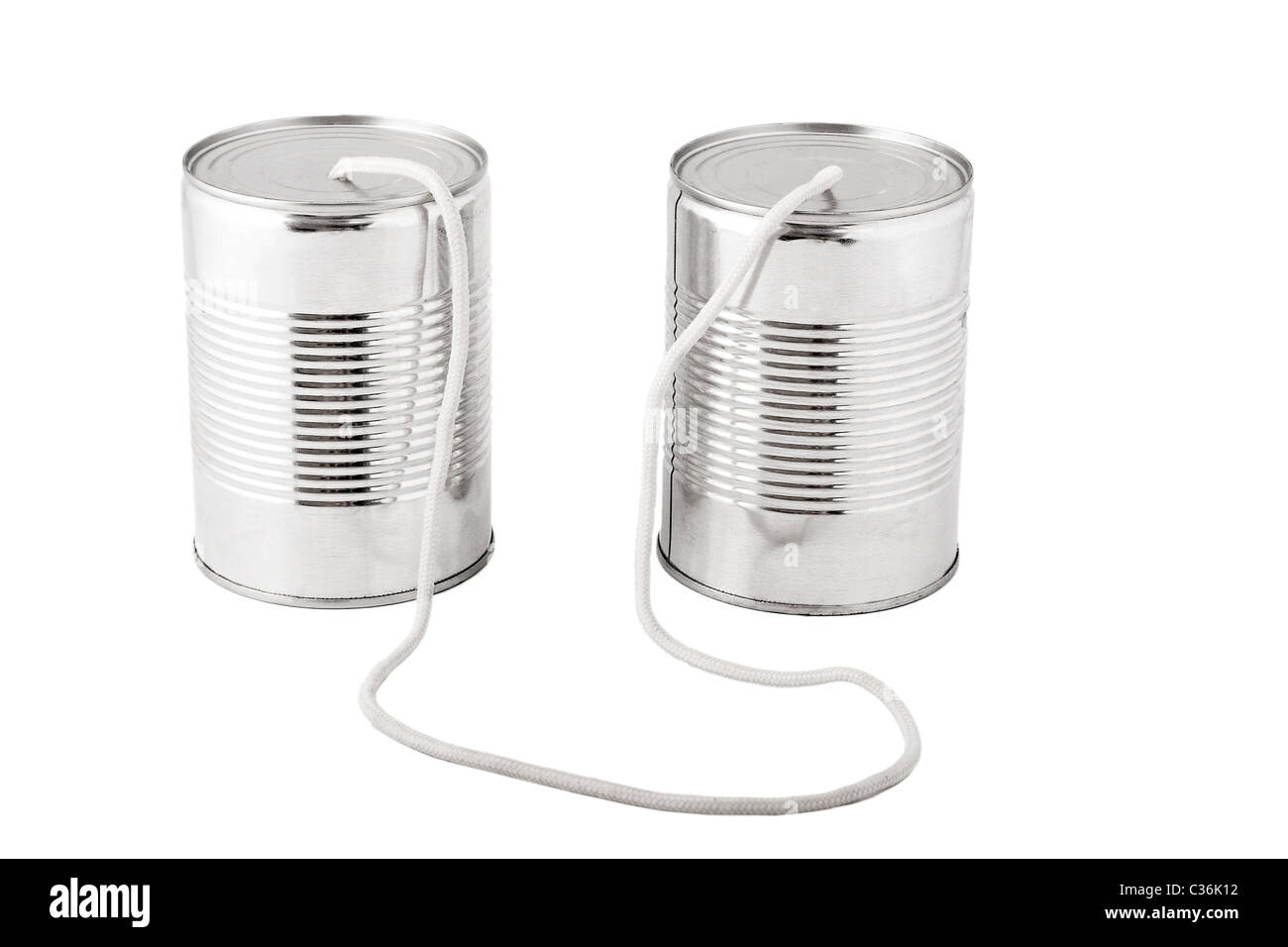 Closeup of tin cans telephone connected by string on white background