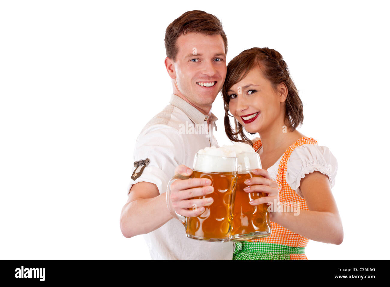 Happy Bavarian man and woman in dirndl with oktoberfest beer stein. Isolated on white background. Stock Photo