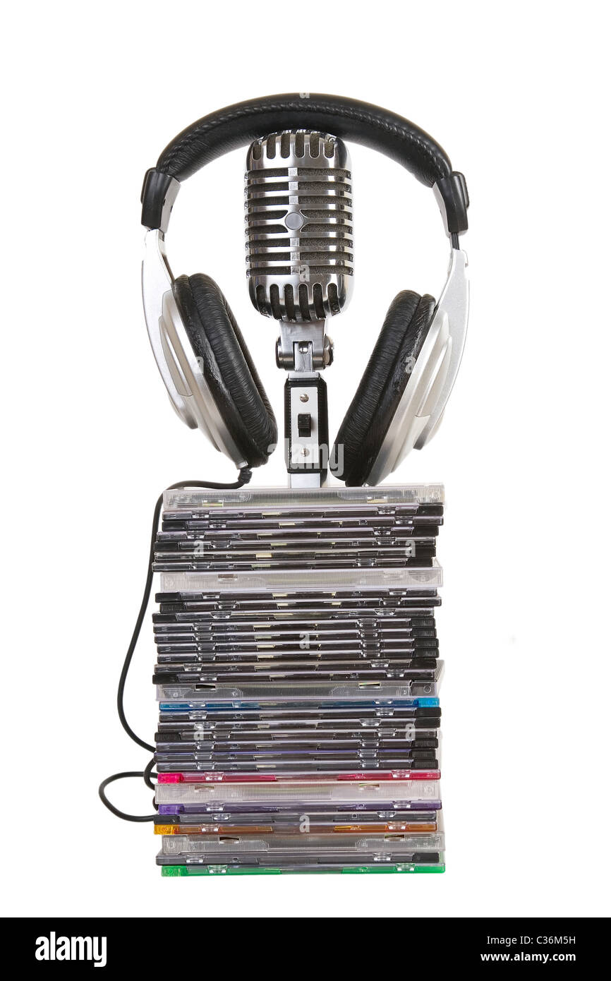 Front view of headphones, vintage microphone, cd, dvd stack Stock Photo