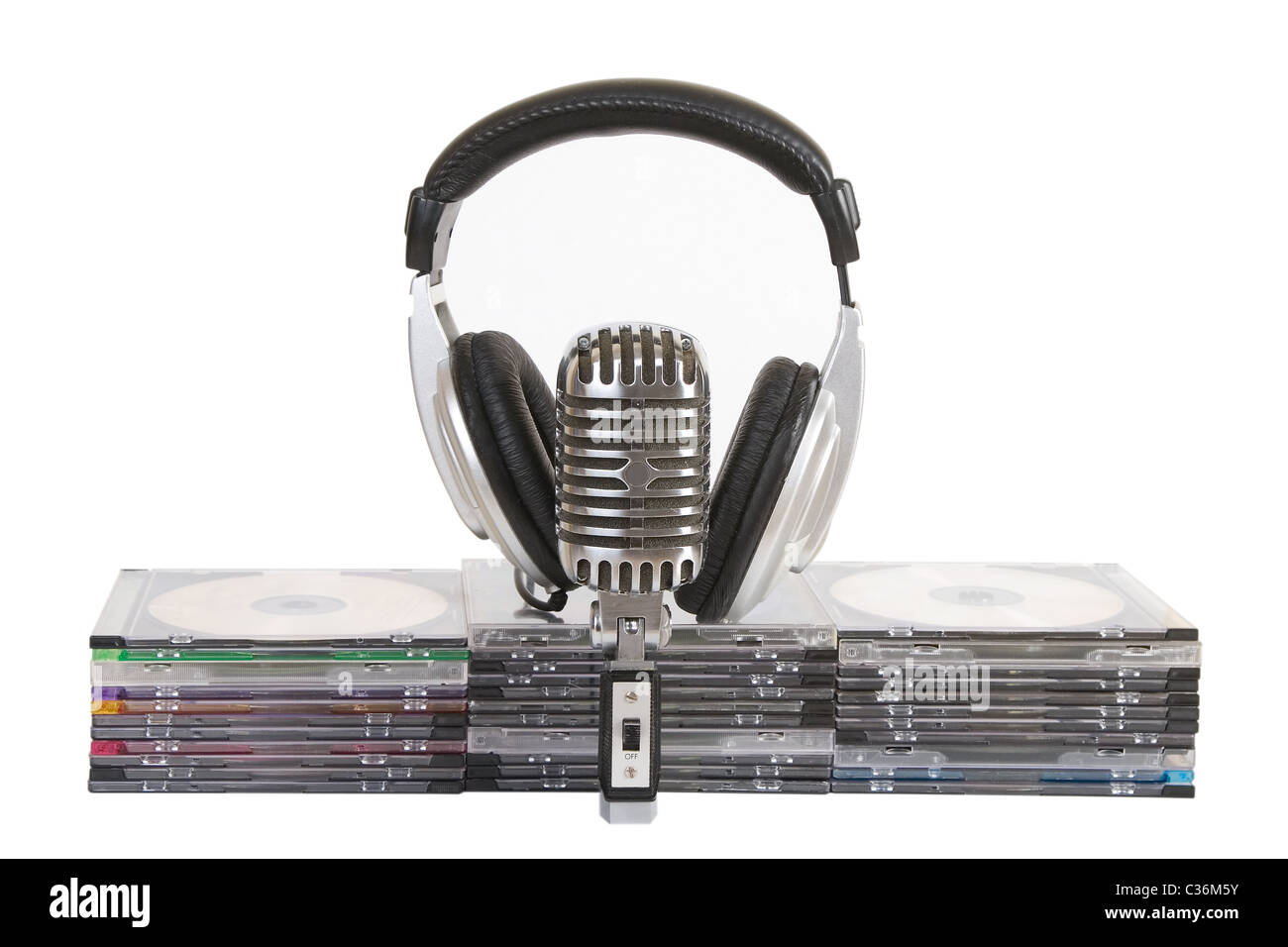 Front view of headphones, vintage microphone, cd, dvd stack Stock Photo