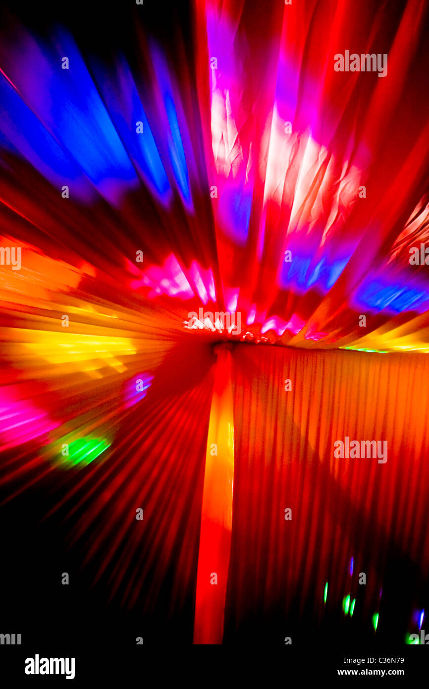 bright vivid colorful disco party lights inside wedding celebration marquee.upright format.copy space. Stock Photo