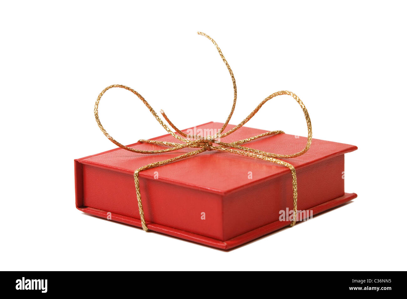 red present box with golden shiny ribbon white background Stock Photo