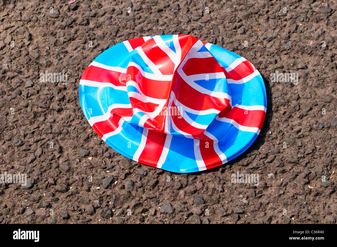 Crushed Union Jack bowler hat lying on the road Stock Photo