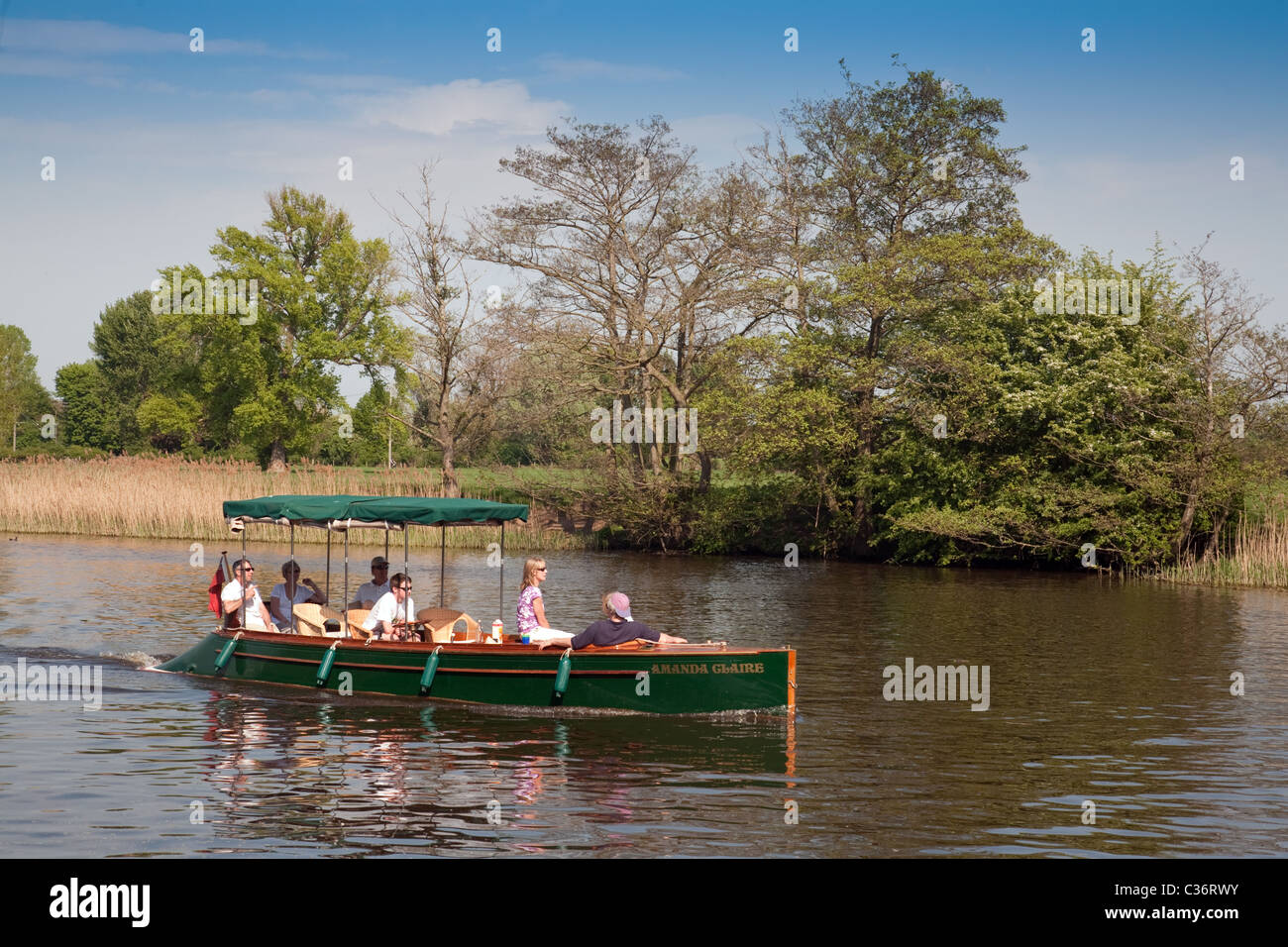A family enjoying a day out in an electric boat on the River Thames at