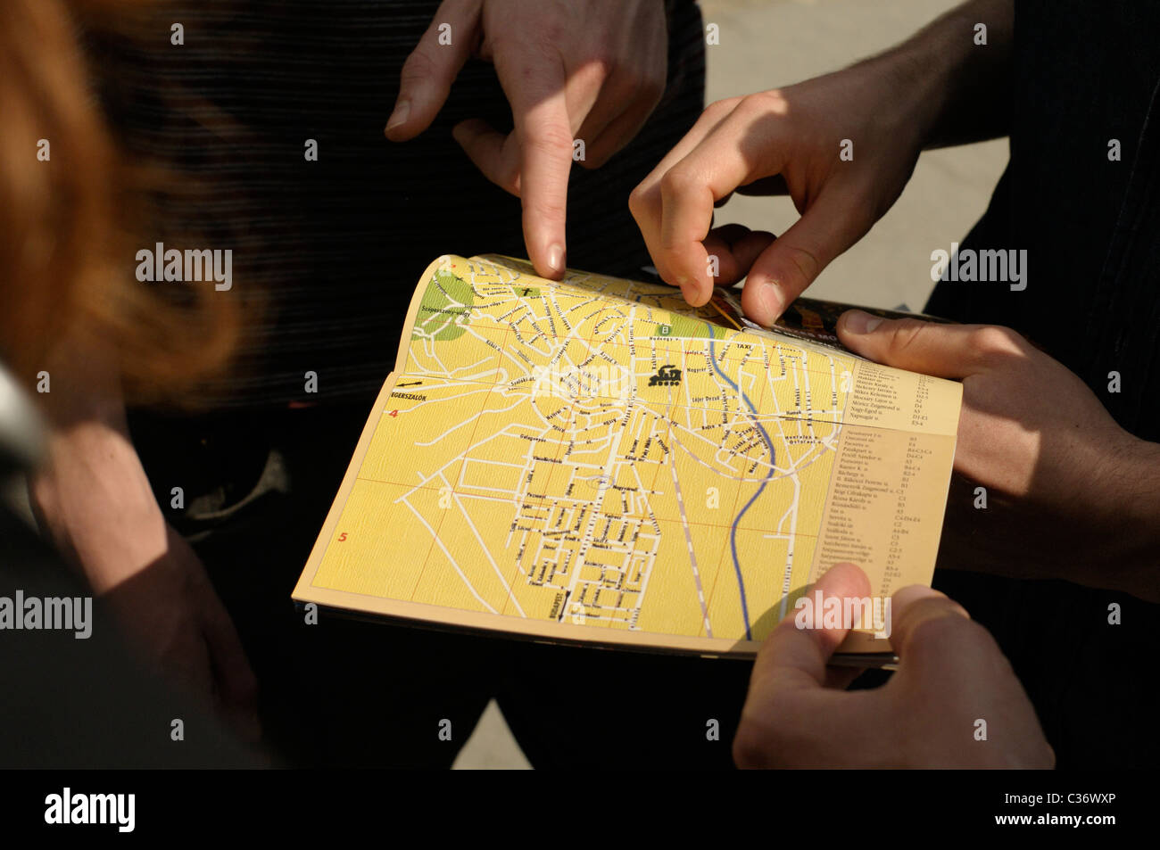 Lost tourists consult a map. Stock Photo