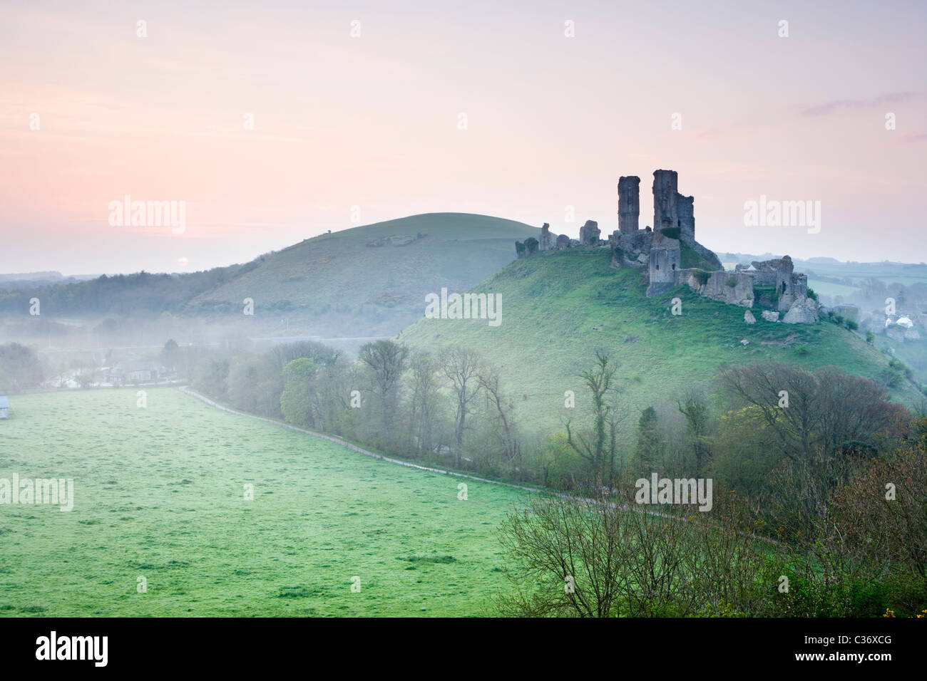 Corfe Castle at sunrise, Dorset, UK Stock Photo