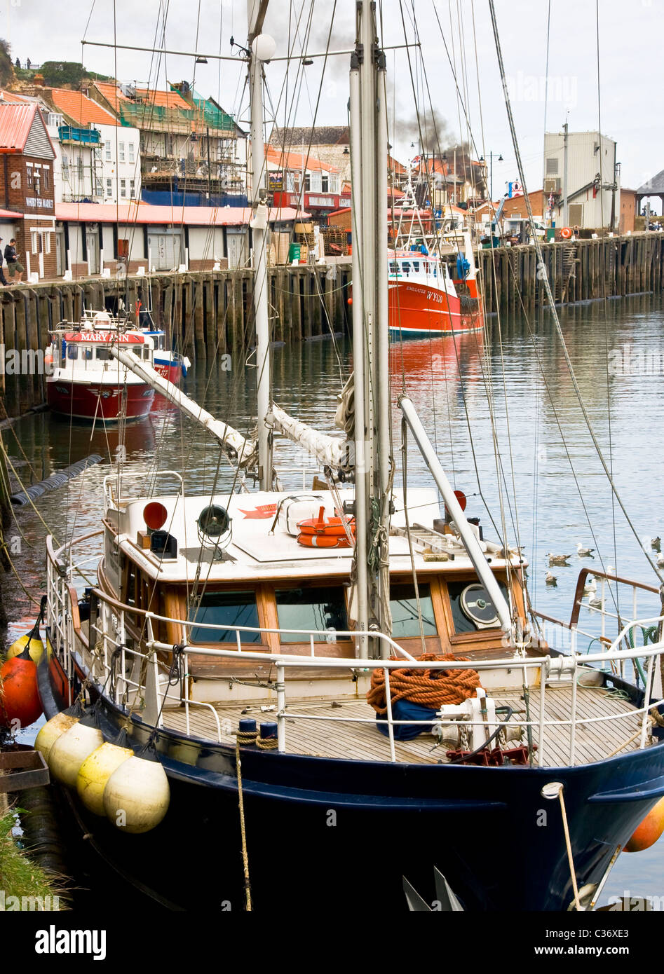 Fishing and sailing boats moored on the quayside Whitby north Yorkshire England Europe Stock Photo