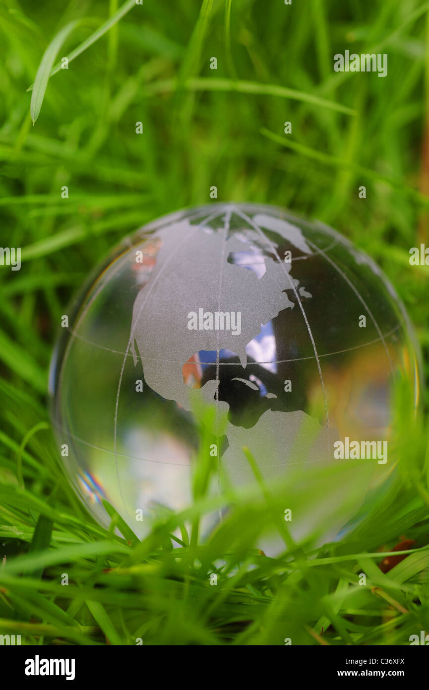 Glass globe in green grass global warming climate change earth ...