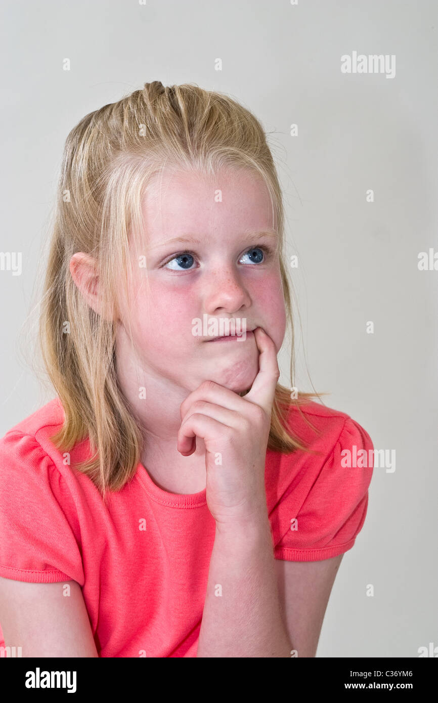 Young girl try to solve a problem 5-6 year old girl. MR © Myrleen Pearson Stock Photo