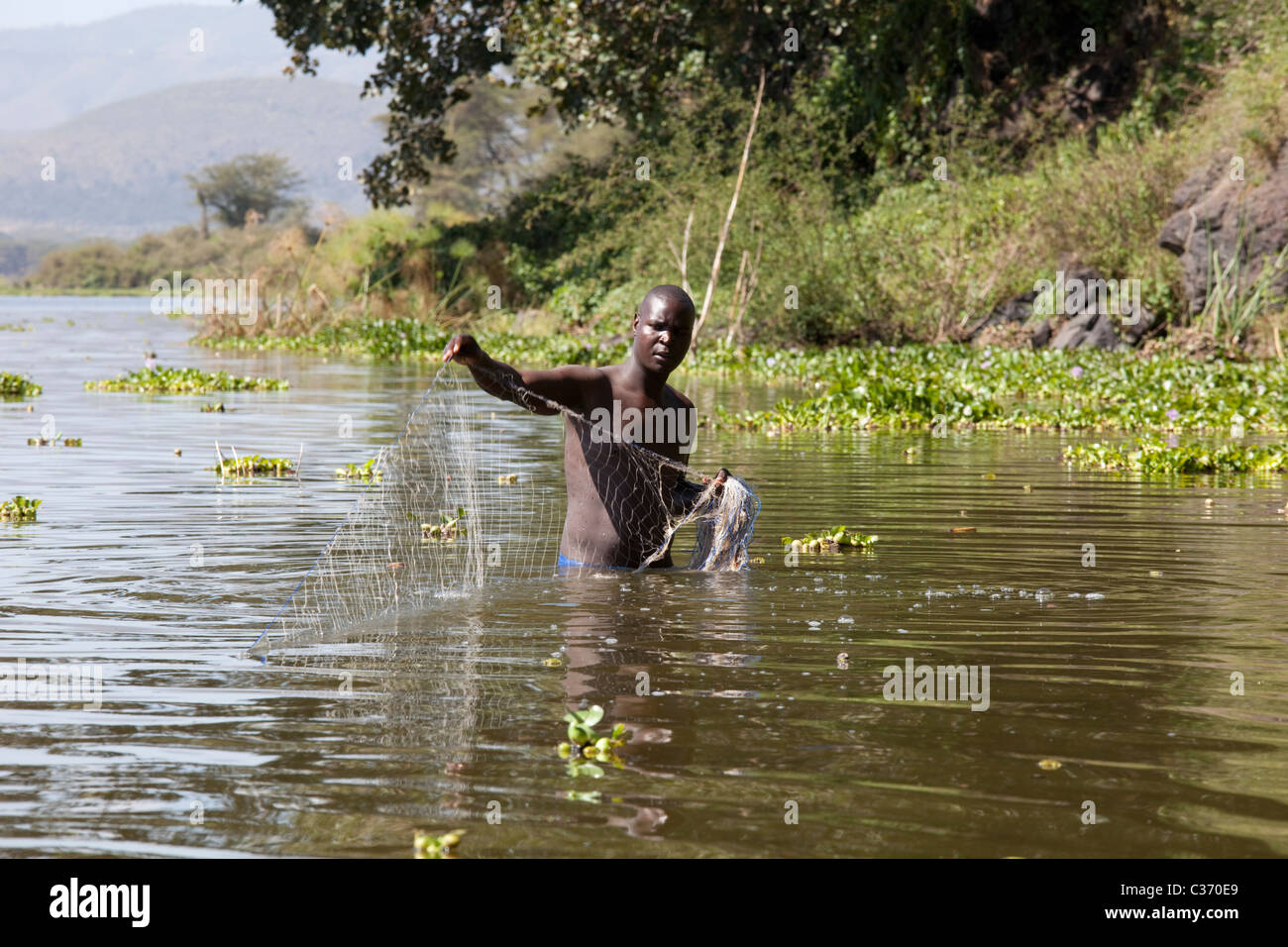 Local fisherman wading with nets Lake Naivasha Rift Valley Kenya Stock Photo