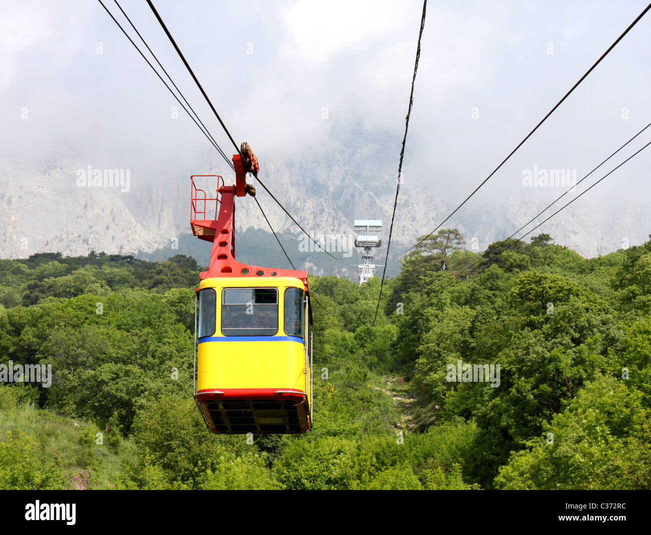 empty aerial ropeway cabin going from mountain Stock Photo