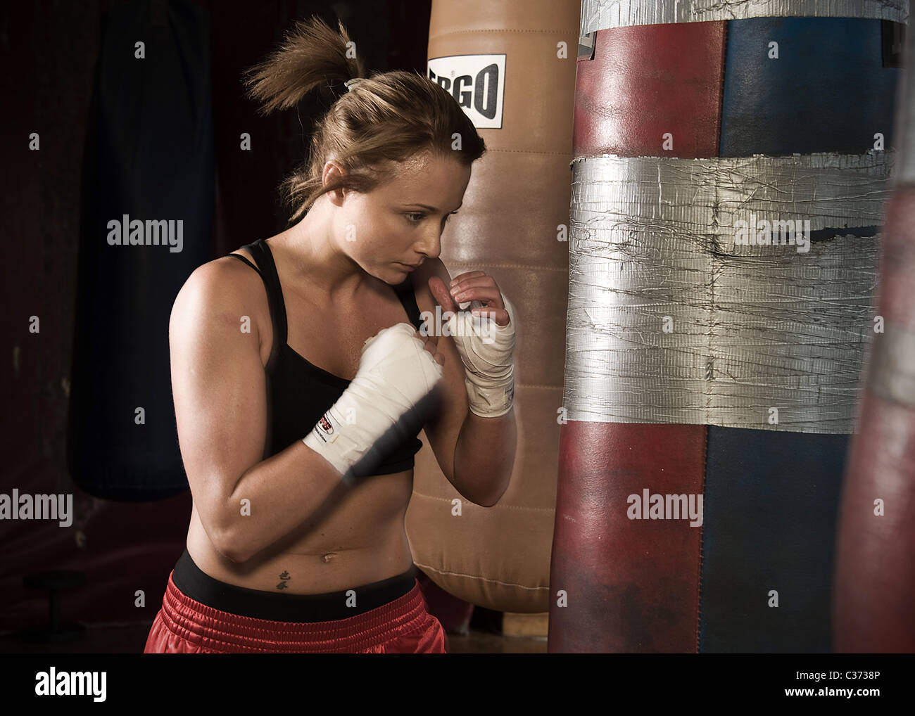 Female boxer training with punch bags Stock Photo