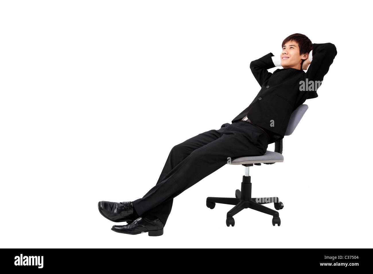 Portrait of a relaxed young businessman sitting on the chair and isolated on white Stock Photo