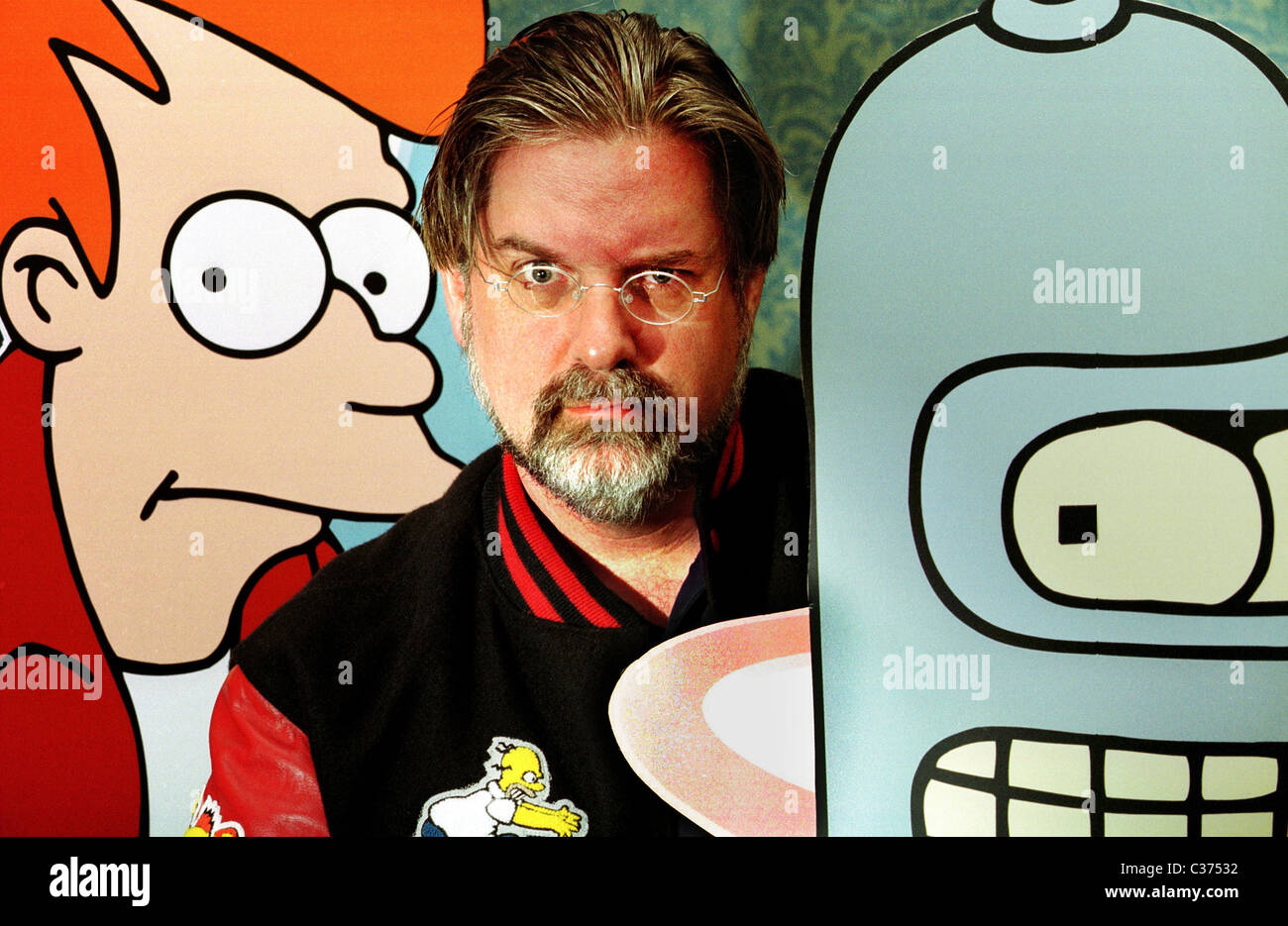 Matt Groening with cardboard cut-outs of Fry and Bender, characters from his animated show, Futurama. Stock Photo