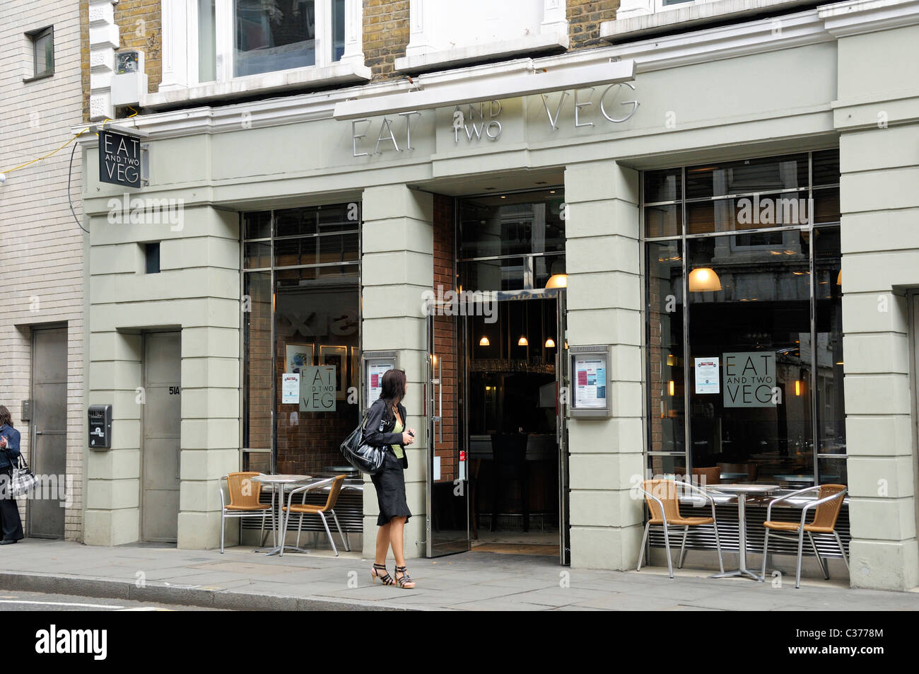 Lady looking into Eat and Two Veg vegetarian restaurant Marylebone High Street London England UK Stock Photo