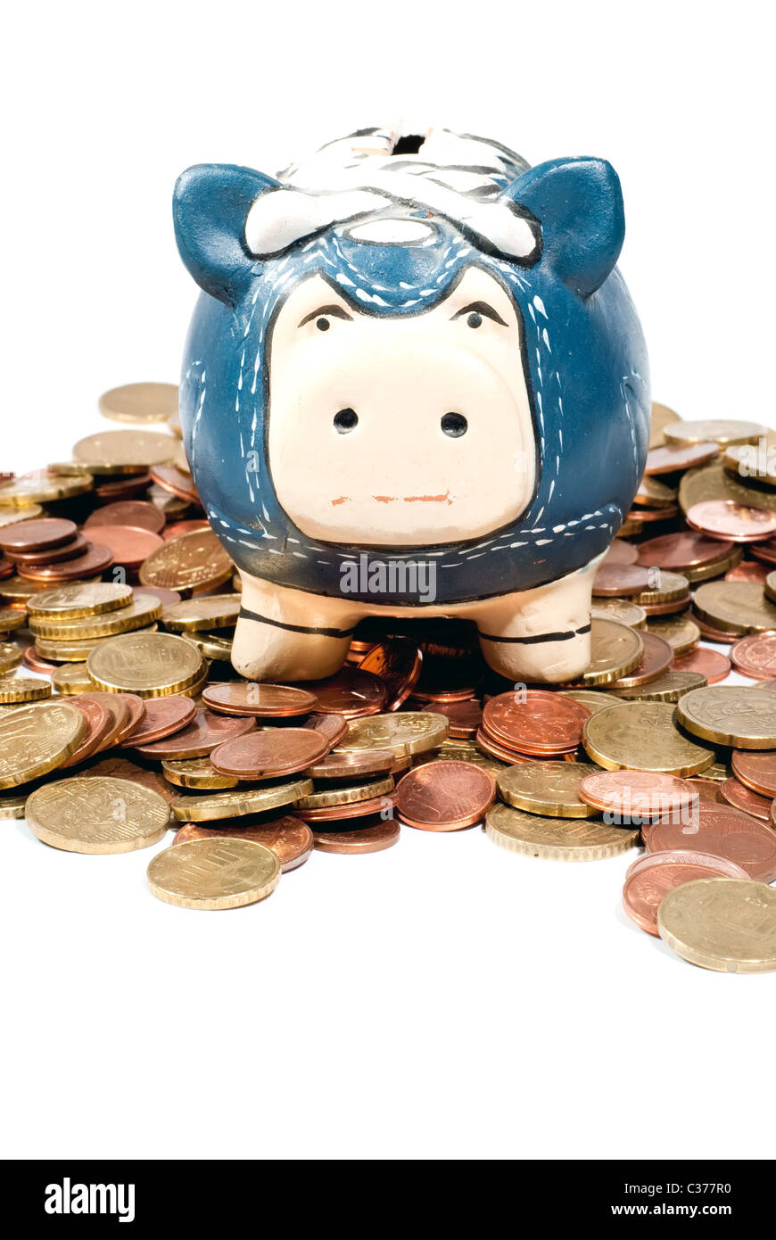 a blue piggy bank standing in coins on white background Stock Photo - Alamy