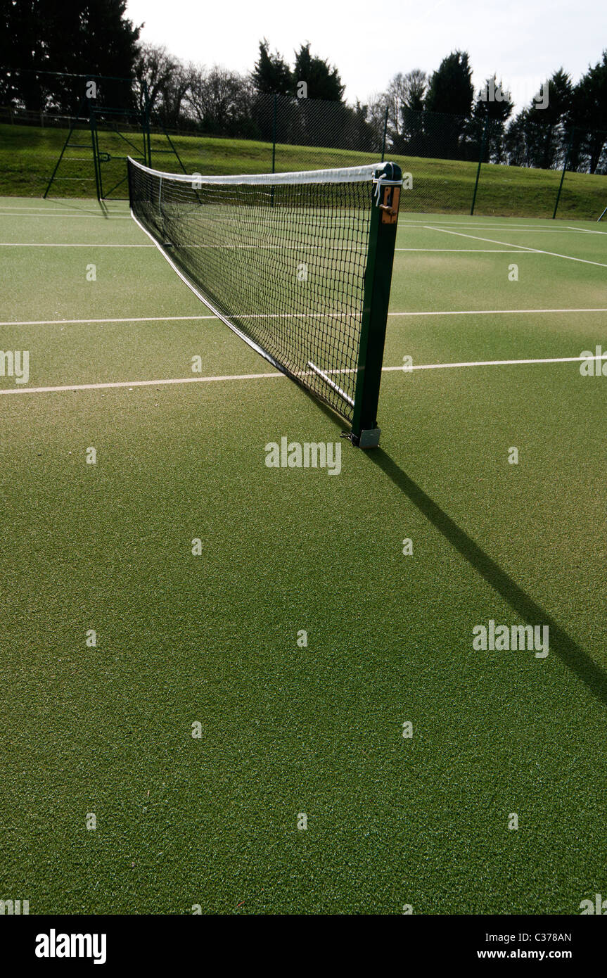 outdoor tennis courts with new nets and green astro turf await players Stock Photo