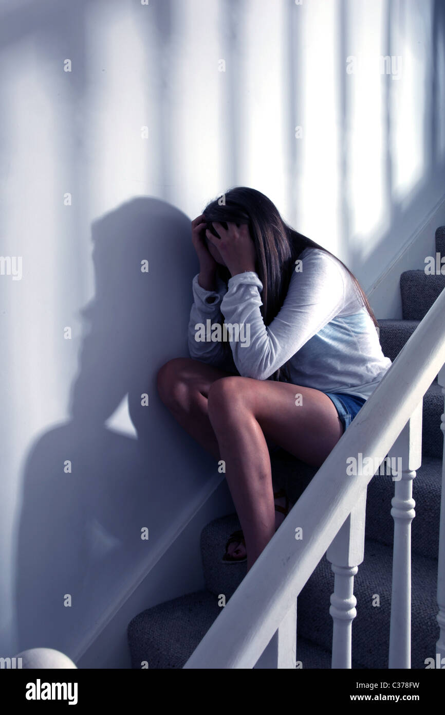 Teenage girl sitting on the stairs alone and upset Stock Photo - Alamy