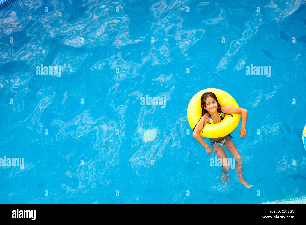 girl in yellow life ring in pool Stock Photo Alamy