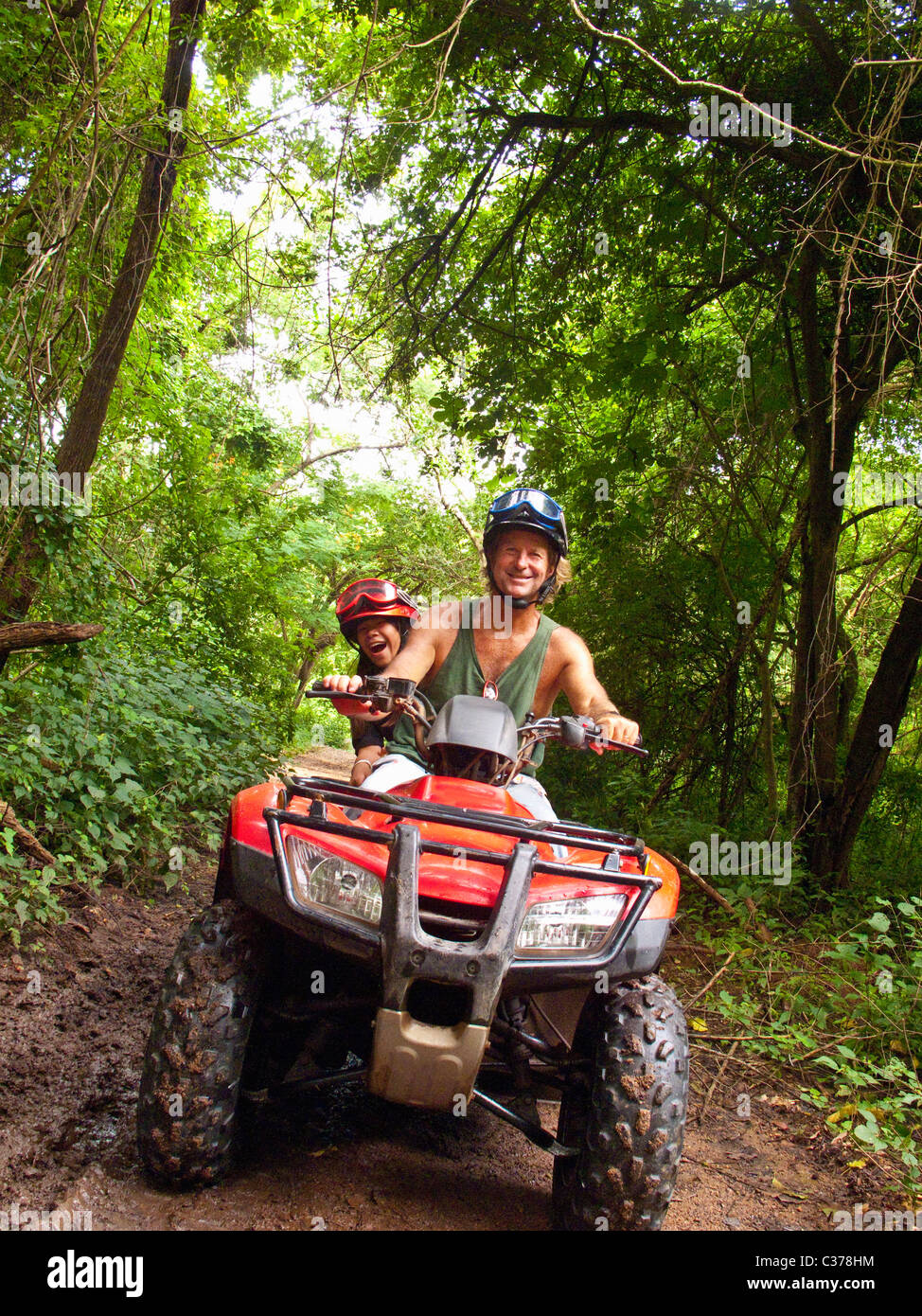 man and girl riding dune buggy Stock Photo