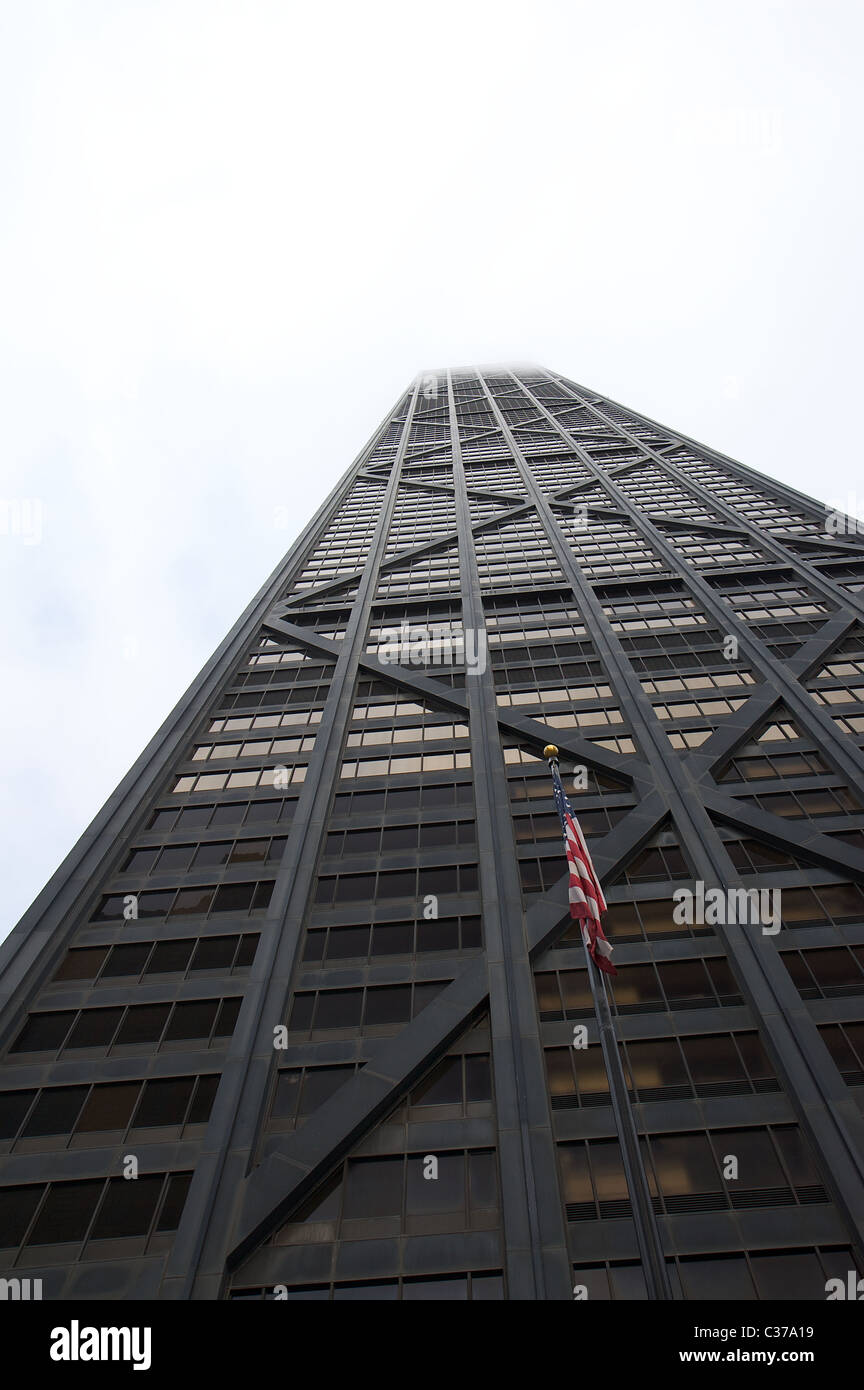 A wide-angle view of Chicago's John Hancock Center (completed 1970), its top stories obscured by clouds Stock Photo