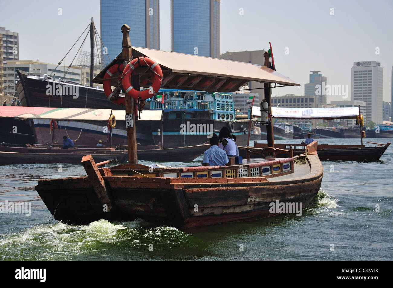 Arab dhow boat crossing Dubai Creek, Bur Dubai, Dubai, United Arab Emirates Stock Photo