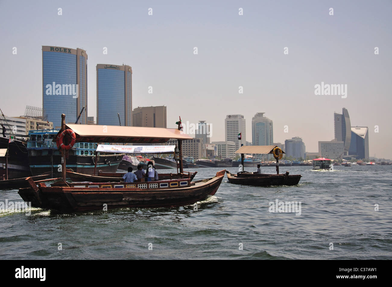 Arab dhow boats crossing Dubai Creek, Bur Dubai, Dubai, United Arab Emirates Stock Photo