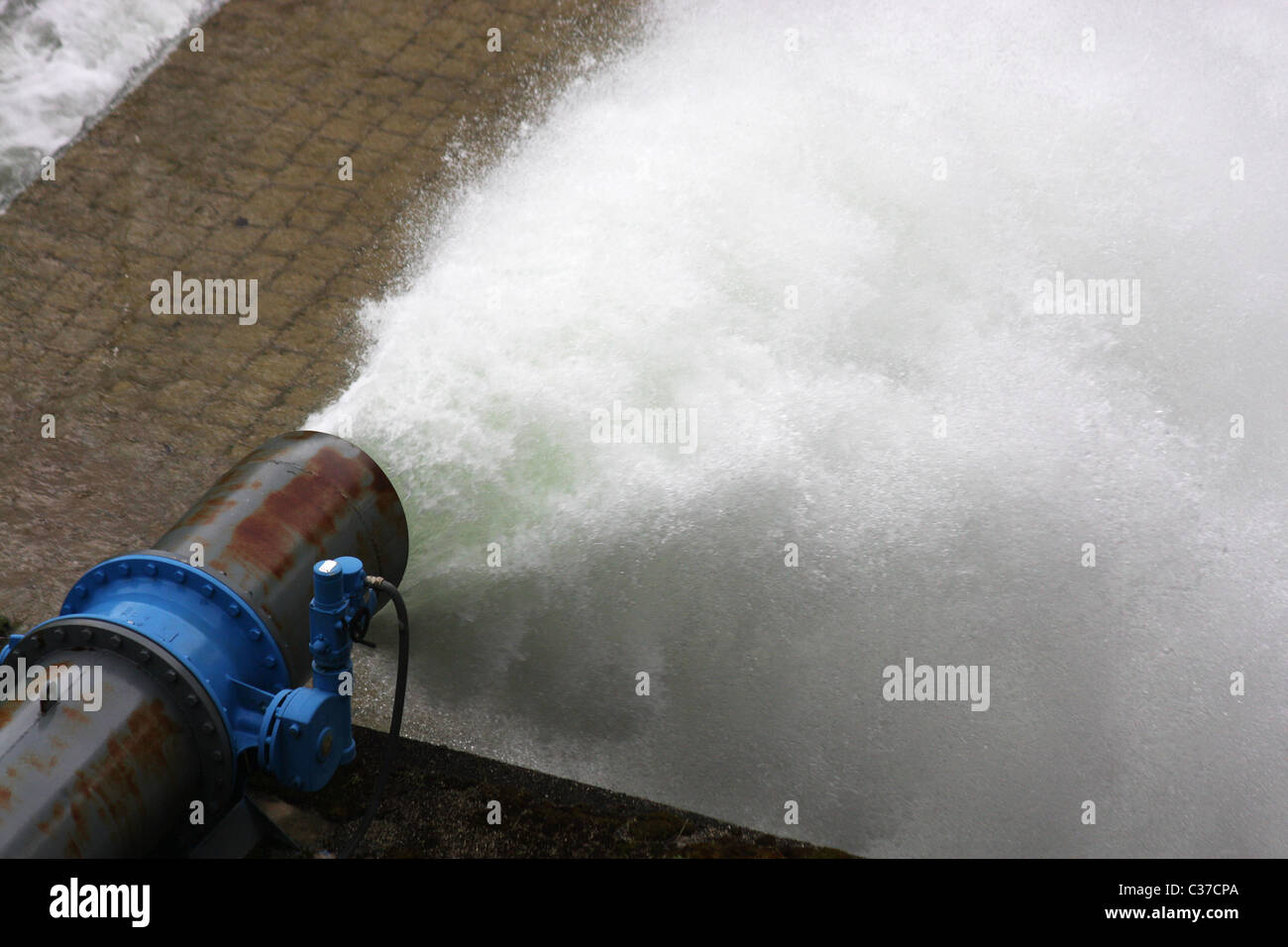 Water gushing from a pipe under great pressure Stock Photo - Alamy