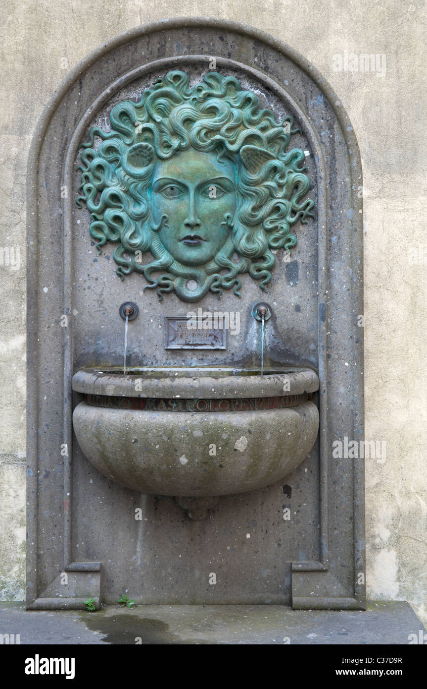 Drinking fountain representing a Gorgon, by sculptor Luciano Mastrolorenzi, in the town of Nemi. Stock Photo