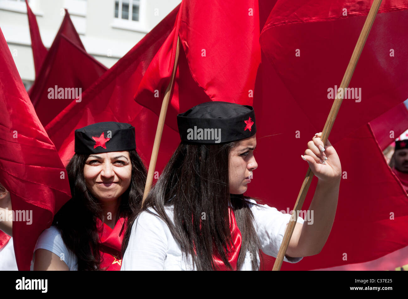 May 1st 2011. May Day demonstration Clerkenwell Green. Two young women from Turkish Kurdish community holding red flags Stock Photo