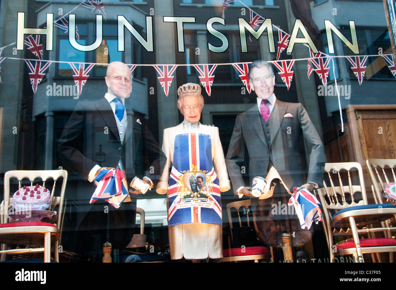 London April 2011. Royal Wedding commemoration. Saville Row window display. Royal Family cut out figures. Stock Photo