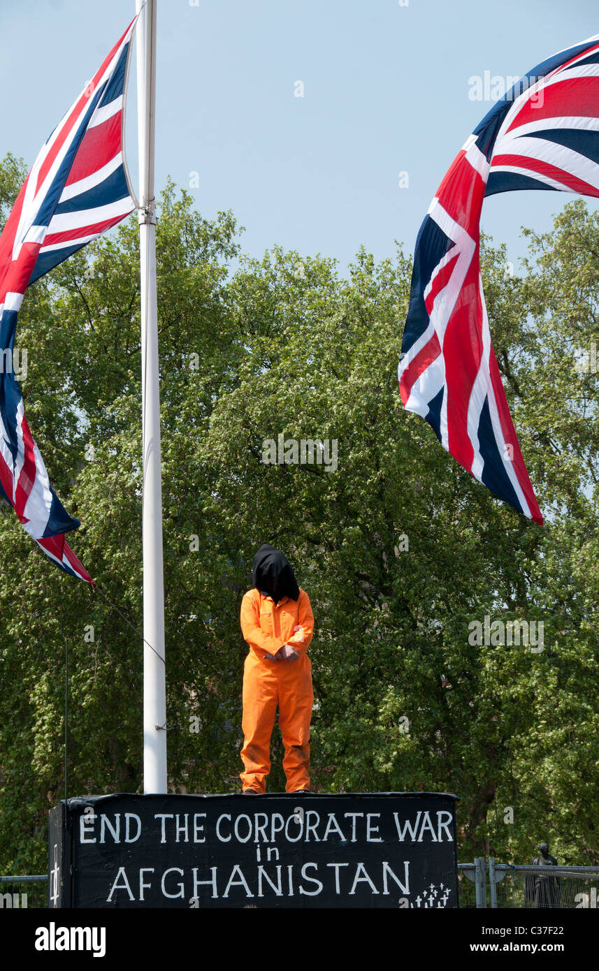 London April 2011. Protest in front of Parliament with protester dressed in orange Guantanamo prison uniform and Union Jacks Stock Photo