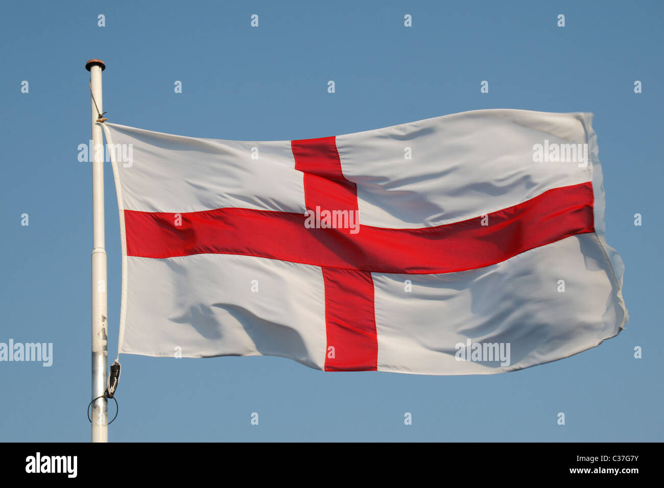 The England flag with a blue sky background. Stock Photo