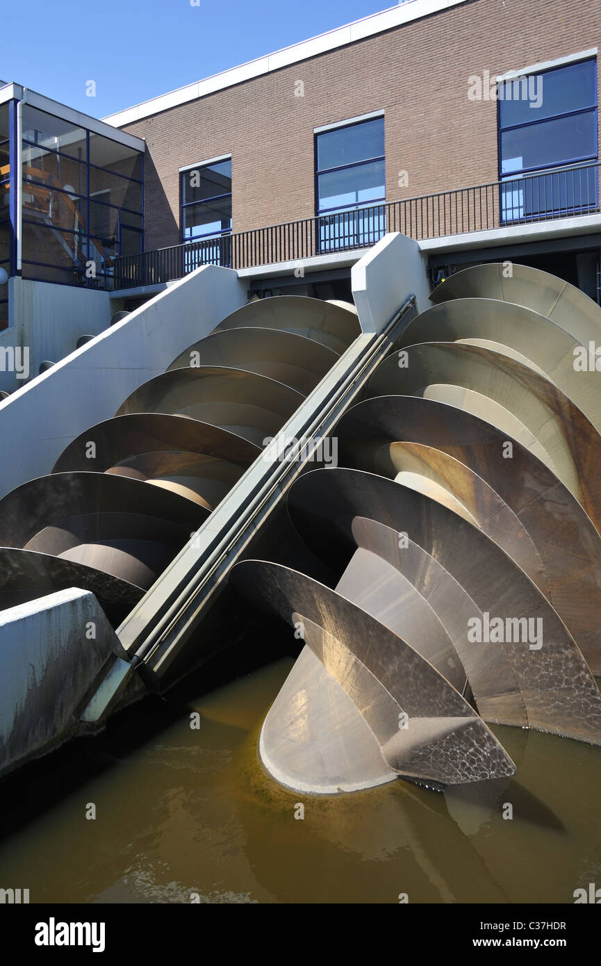 Modern Archimedes screws of pumping station used to drain the polders at Kinderdijk in Holland, the Netherlands Stock Photo