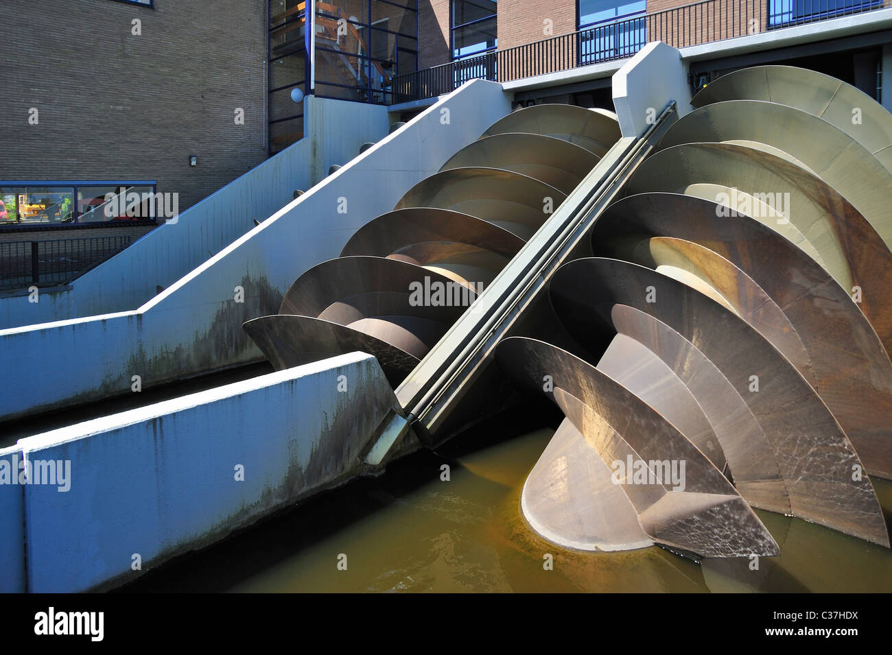 Modern Archimedes screws of pumping station used to drain the polders at Kinderdijk in Holland, the Netherlands Stock Photo