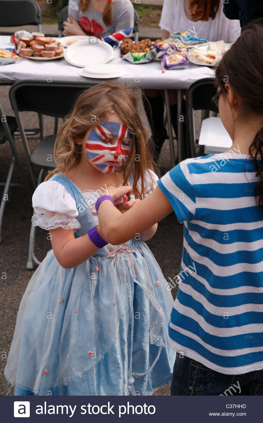 Small Girl In Party Dress With Union Jack Painted Face At Stock