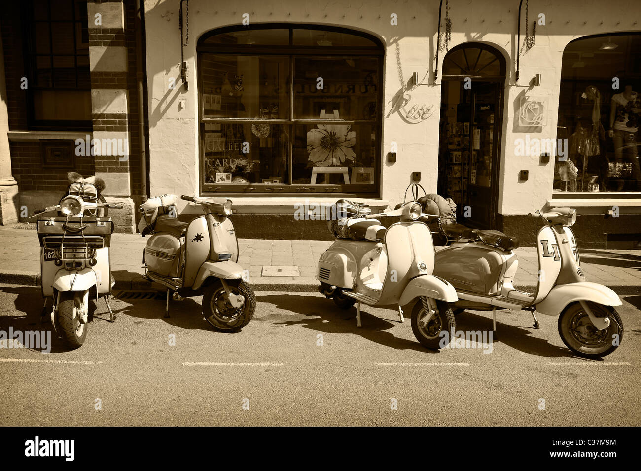 Motor Scooters parked in a street in Shaftesbury, Dorset, England, UK