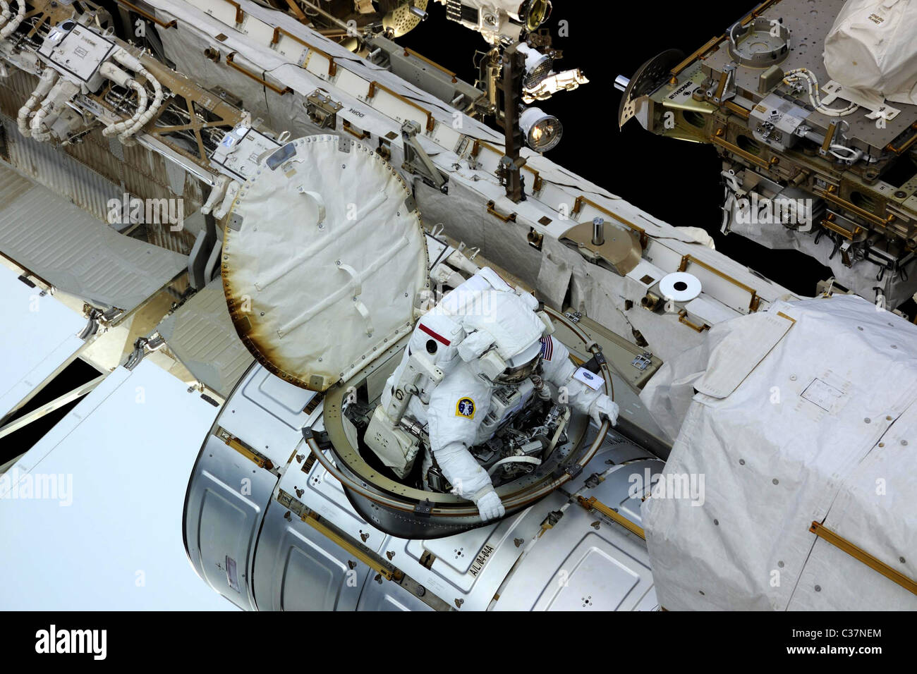 Astronaut Doug Wheelock emerges from the craft into the daylight on the Expedition 24 mission's second spacewalk. Stock Photo