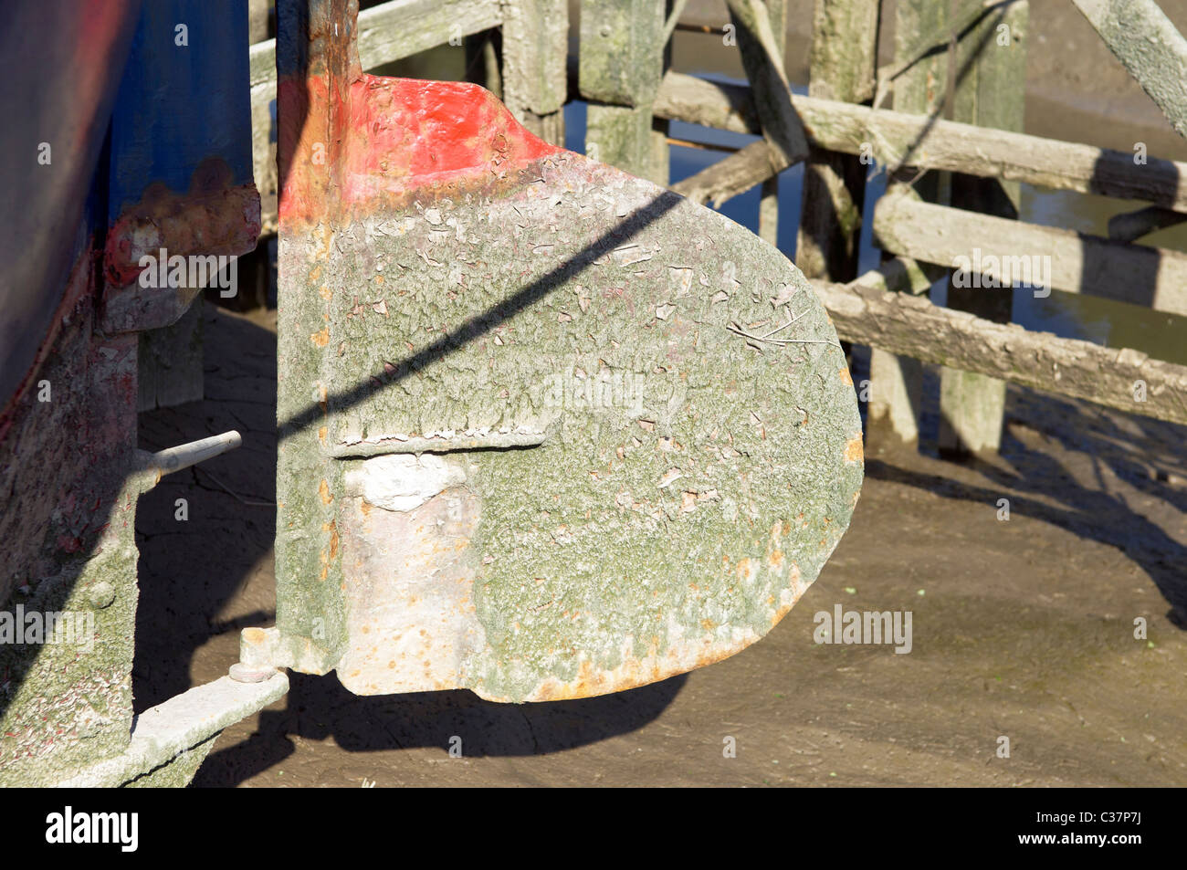 Old boat rudder on dry land Stock Photo