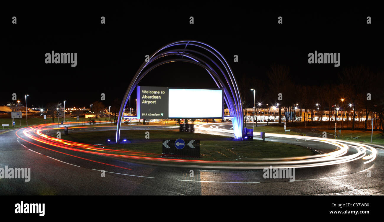 Traffic light trails seen at night iat the entrance to Aberdeen airport in the city of Aberdeen, Scotland, UK Stock Photo