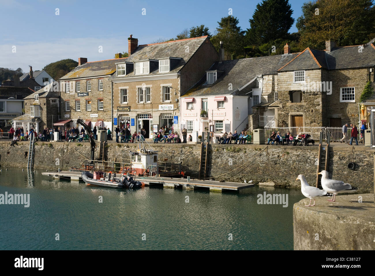 Harbour wall & quayside buildings / building / shops / shop / pub / pubs / house home / homes on quay side. Padstow Cornwall UK Stock Photo