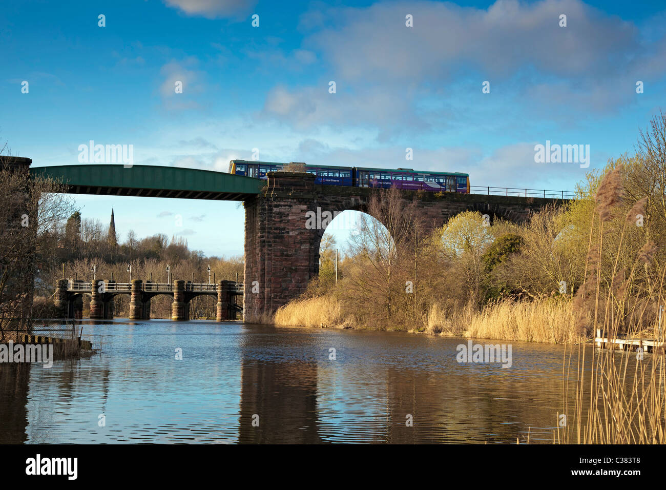 Northern Rail DMU train crosses viaduct over the River Weaver at