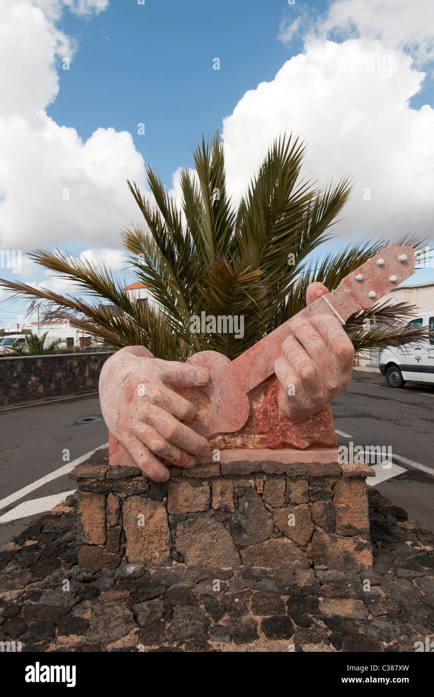 clay statue of hands playing the guitar Lajares Fuerteventura Canary Islands Stock Photo